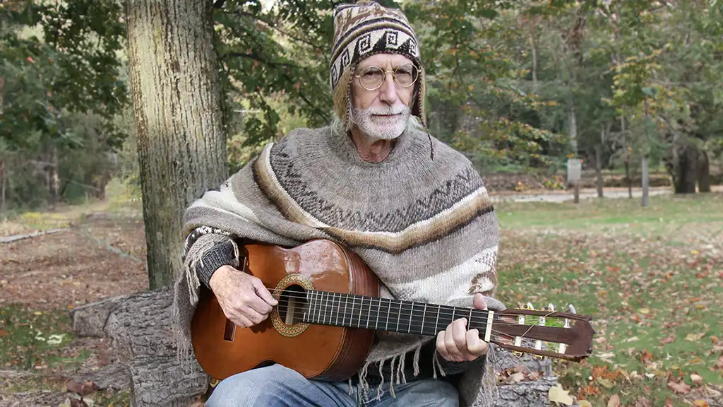 Peruvian poncho Unique Christmas gifts man with poncho and guitar in an undergrowth