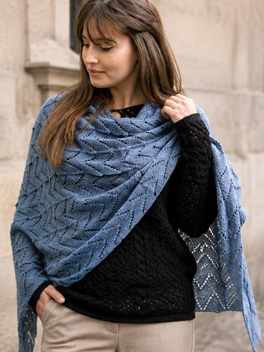 Autumn layered outfit with black jumper and blue shawl Woman wearing a black openwork jumper with a blue shawl for an autumn layered outfit